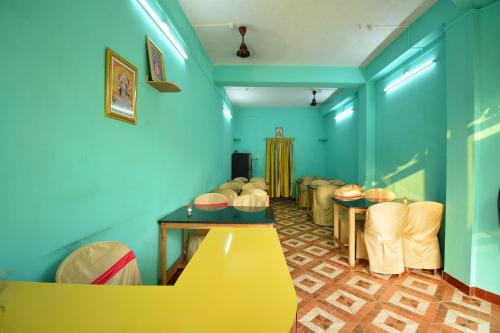 a waiting room with a row of tables and chairs at OYO Flagship Hotel Gloria Inn in Agartala