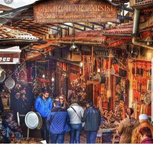 a group of people standing in a market at snowrose hotel in Şahinbey