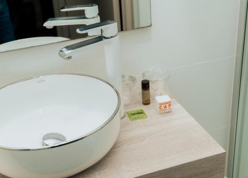 a bathroom with a white sink and a mirror at Hotel d'Alcantara in Tournai
