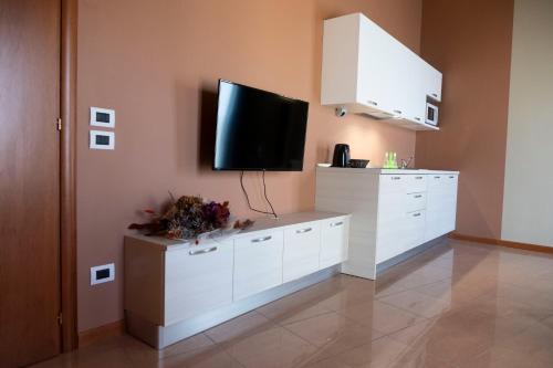 a living room with a flat screen tv on a wall at CallMe Crema - Struttura in centro storico in Crema