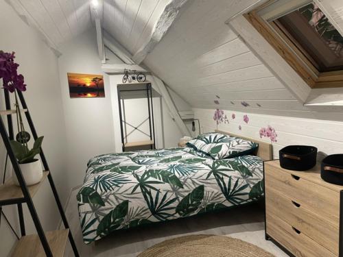 - une petite chambre avec un lit et une commode dans l'établissement L’escale féerique, à Auxerre