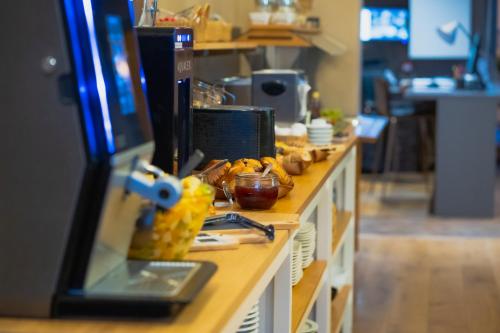 a buffet line with food on it in a restaurant at Hotel d'Alcantara in Tournai