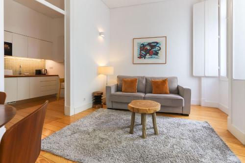 a living room with a couch and a table at Alfama Deluxe by Homing in Lisbon