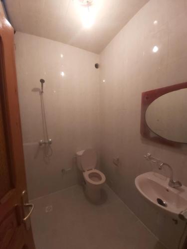 a bathroom with a toilet and a sink at Résidence Taghazout Oufella by Surf Times in Taghazout