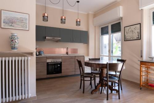 a kitchen with a wooden table and chairs and a dining room at CASA MIRELLA in Casale Monferrato
