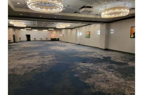 an empty room with a large room with chandeliers at Crowne Plaza Dallas Downtown by IHG in Dallas