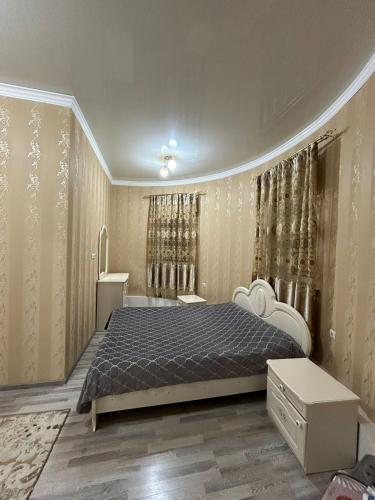a bedroom with a bed and a bath room at Уютная квартира комфорт класса111 in Astana