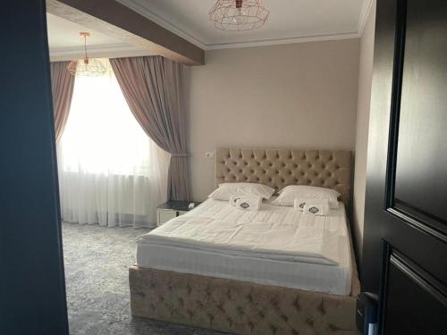 a bedroom with a bed with two pillows on it at Pensiunea Ramina in Adjud