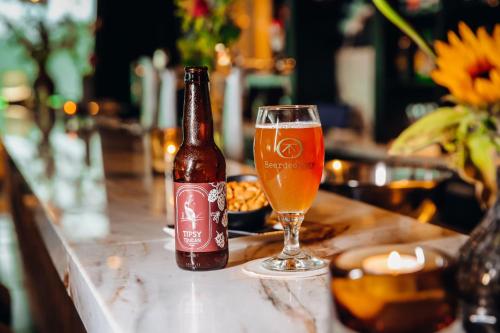 a bottle of beer and a glass on a bar at Van der Valk Hotel Enschede in Enschede