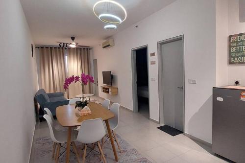 a kitchen and a dining room with a table and chairs at Tangerine Suite @ Near KLIA @ERL in Sepang