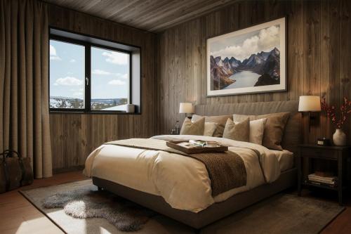 a bedroom with a large bed and a large window at Pellestova Hotell Hafjell in Hafjell