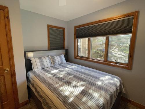 a small bedroom with a bed and a window at Chillaxin in McHenry