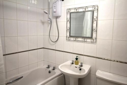 a white bathroom with a sink and a mirror at Doncaster - Town Centre - 2 Bedrooms & Sofa Bed - Very Quiet Location in Doncaster