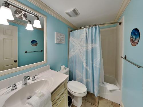 a bathroom with a sink and a toilet and a shower at Brass Rail 119 in Tybee Island