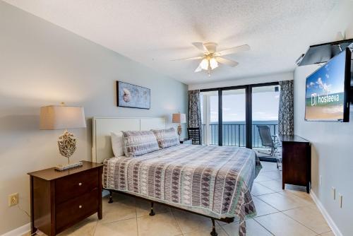 a bedroom with a bed and a ceiling fan at Phoenix I 1085 in Orange Beach