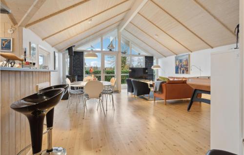 エーベルトフトにあるAmazing Home In Ebeltoft With 4 Bedrooms And Wifiのダイニングルーム、リビングルーム(テーブル、椅子付)