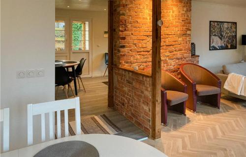 a living room with a brick wall and a dining room at 2 Bedroom Amazing Home In Örkelljunga in Orkelljunga