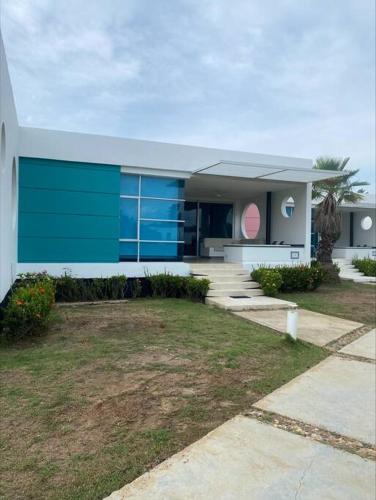 a house with a blue and white at casa de descanso pto velero in Barranquilla