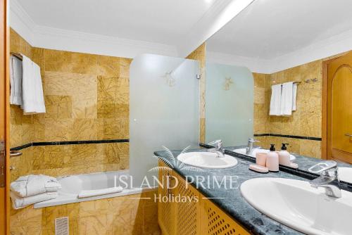 ein Badezimmer mit zwei Waschbecken und einer Badewanne in der Unterkunft El Nautico Relax 2 in Golf del Sur in San Miguel de Abona