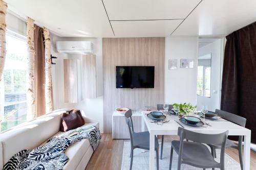 a living room with a white couch and a table at San Benedetto Camping Relais in Peschiera del Garda