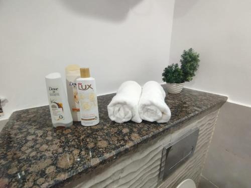 a counter top with towels and products on it at One Bed Appartment in GoldCrest Mall and residency DHA Lahore in Lahore