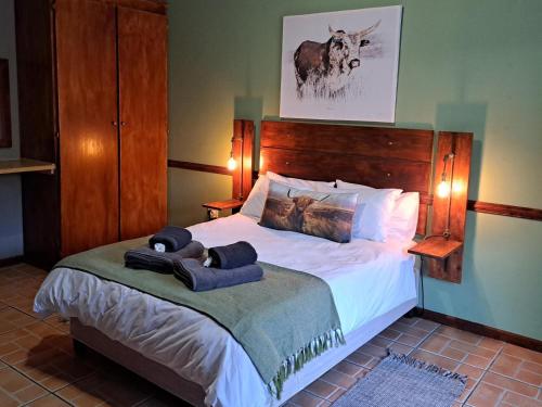 a bedroom with a bed with two towels on it at Morgenbos Guesthouse in Upington