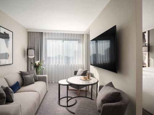 a living room with a couch and a table at Nobu Hotel London Portman Square in London