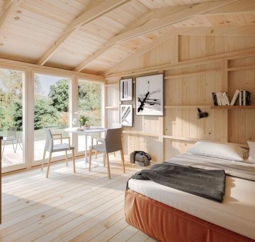 a bedroom with a bed and a table and chairs at Sjugare Gård Glamping in Leksand