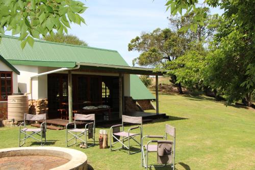 a group of chairs sitting in front of a building at Breede Bush Camp in Bakklysdrift