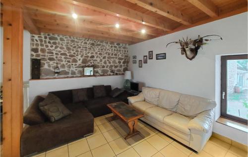 a living room with a couch and a table at 2 Bedroom Awesome Home In Bas-En-Basset in Bas-en-Basset