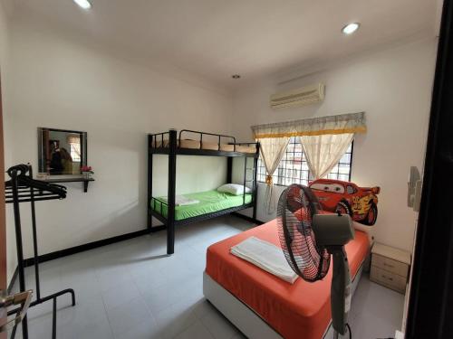 a bedroom with two bunk beds and a mirror at Homestay Melor Serendah in Serendah