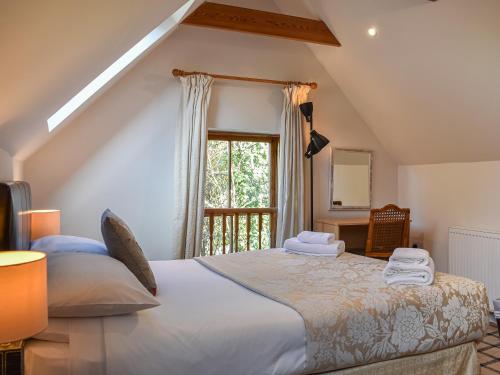 a bedroom with a large bed with a window at Allerton House Stable in Jedburgh