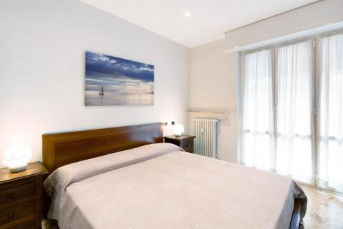 a bedroom with a bed and a large window at Le Vele in Albissola Marina