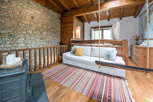a living room with a couch on a porch at Egur Etxe I Caserío Vasco I Jardín I Porche I BBQ I Chimenea in Zárate