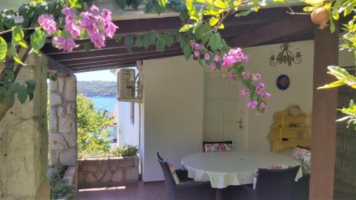 a room with a table and a view of the ocean at Apartment Maja in Mali Lošinj