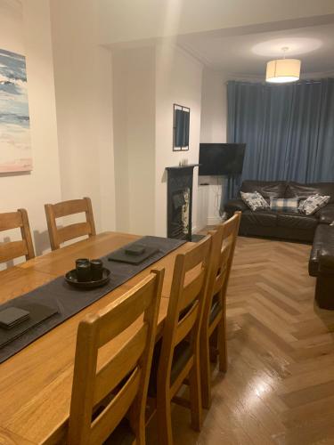 a kitchen and living room with a table and chairs at Prospect House - Elegant 4-Bed Family Escape Near Ward Park & Marina in Bangor