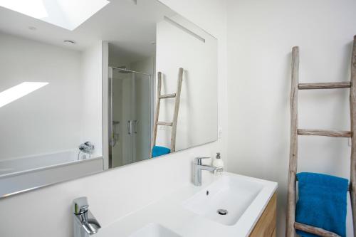 a bathroom with a sink and a mirror at L'aquarium - Villa au centre d'Erquy in Erquy