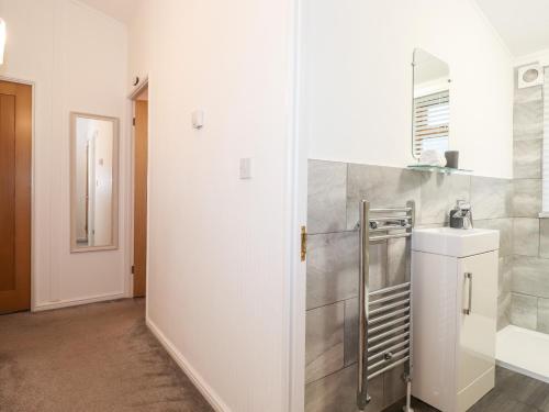 a white bathroom with a sink and a toilet at Ruskin Lodge in Windermere