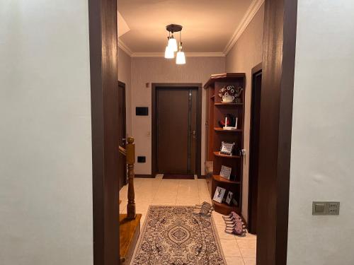 a hallway with a door and a rug on the floor at Beautiful Guest House Qusar in Qusar