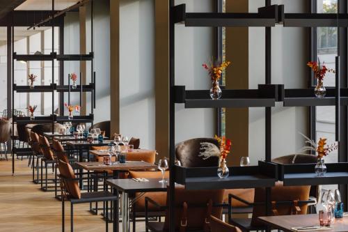 a row of tables and chairs in a restaurant at TRIBE Lyon Croix Rousse in Lyon