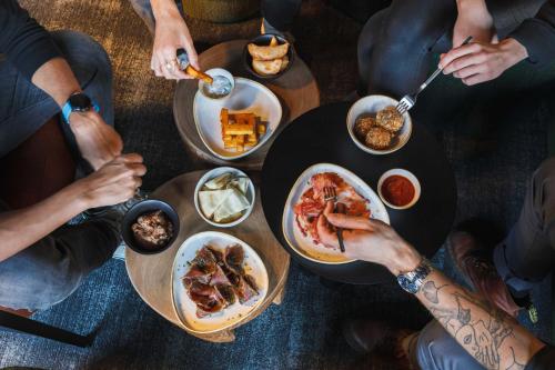 a group of people sitting around a table eating food at TRIBE Lyon Croix Rousse in Lyon