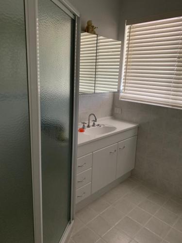 a bathroom with a shower and a sink at Hamersley Hacienda in Perth