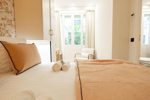 a bedroom with a large bed with two pillows on it at New Luxury apartment - 4 people in Paris