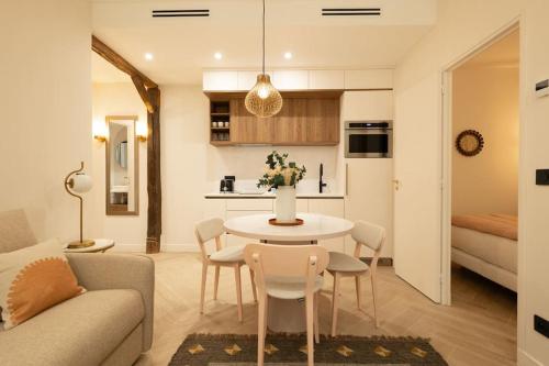 a kitchen and a living room with a table and chairs at New Luxury apartment - 4 people in Paris