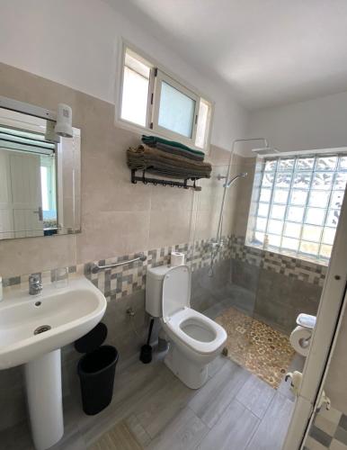 a bathroom with a toilet and a sink at LES OLIVIERS Villa N1 avec piscine privée in Oualidia