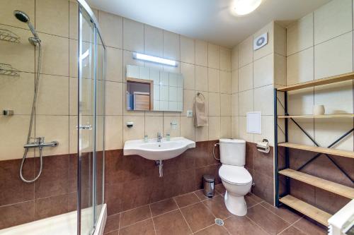 a bathroom with a toilet and a sink and a shower at Luxury Flat in Grand Resort Pamporovo in Pamporovo