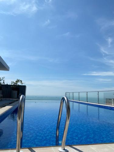 a swimming pool with a view of the ocean at Hotel Windy Terrace in Cox's Bazar