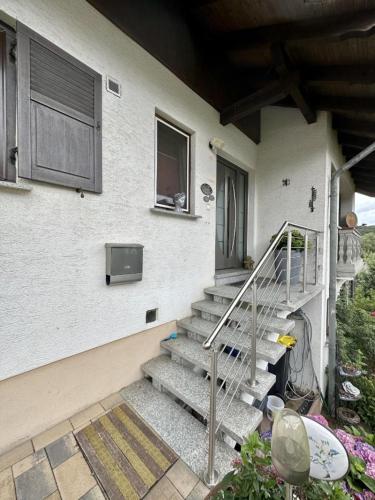 a house with a staircase leading up to a door at Landharmonie Knüll in Frielendorf