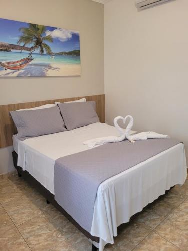 Una cama o camas en una habitación de Pousada Concha Dourada