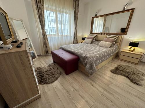 a bedroom with a bed and a large mirror at River Lux in Bacău